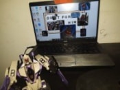 Blitzwing in front of a laptop